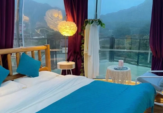 Panoramic view of clear bubble house with mountain scenery background